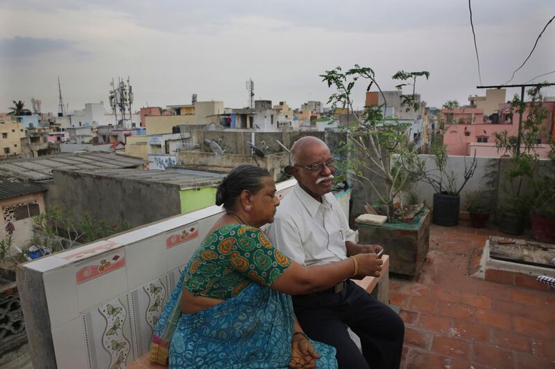 Retired Indian civil servant R. Devarajan with his wife Padmini sit at the terrace of their house equipped with rain water harvesting system in Chennai, India. AP