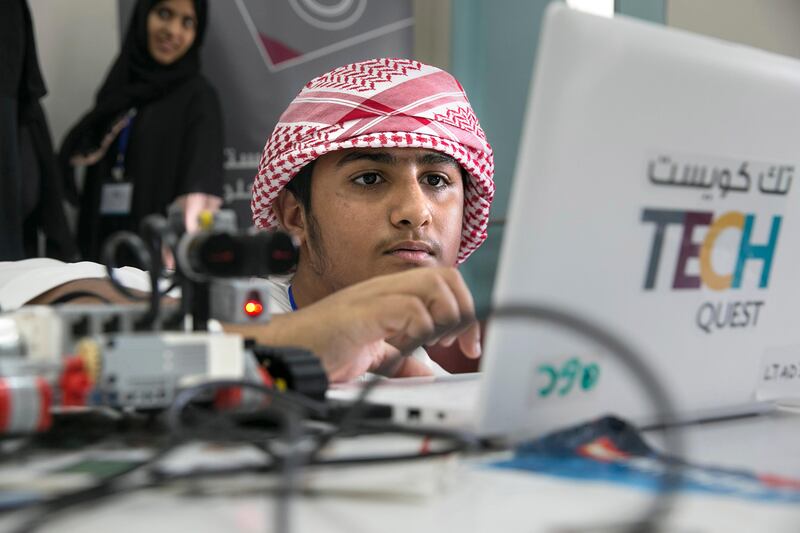 Abdullah Ali Ameri, 14, programs a robot at the Higher Colleges of Technology Men's College in Abu Dhabi designed to encourage more youngsters into a career in the sciences. Silvia Razgova / The National