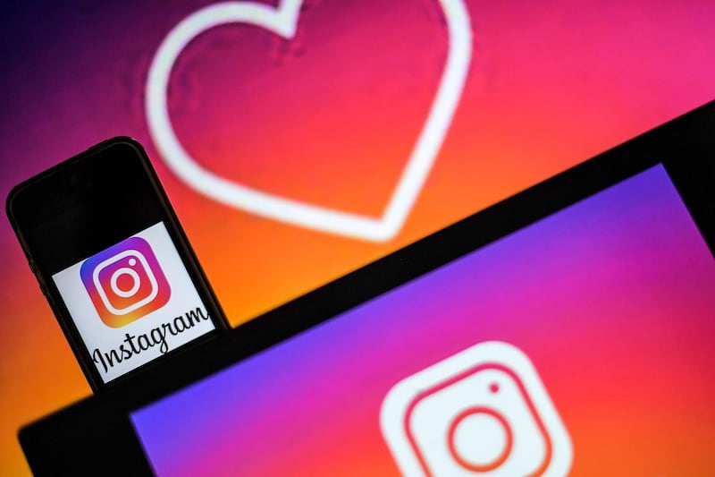 (FILES) In this file photo taken on May 2, 2019, logos of US social network Instagram are displayed on the screen of a computer and a smartphone in Nantes, western France. Instagram on July 9, 2019 announced new features aimed at curbing online bullying on its platform, including a warning to people as they are preparing to post abusive remarks. / AFP / LOIC VENANCE
