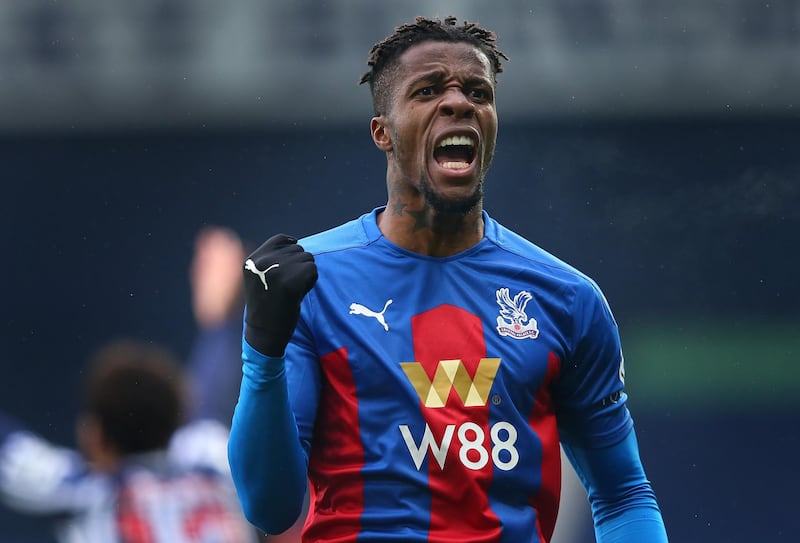 WEST BROMWICH, ENGLAND - DECEMBER 06:  Wilfried Zaha of Crystal Palace celebrates after crossing the ball forcing Darnell Furlong of West Bromwich Albion (not in picture) to put the ball into his own net scoring an own goal, the first goal for Crystal Palace during the Premier League match between West Bromwich Albion and Crystal Palace at The Hawthorns on December 06, 2020 in West Bromwich, England. (Photo by Alex Livesey/Getty Images)