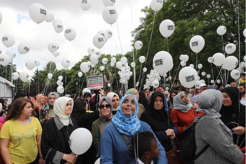 Peace activists hold balloons during a demonstration in solidarity with the people of northwest Syria where clashes have erupted, as they gather in Ankara.  AFP