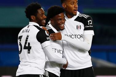 Fulham's Josh Maja celebrates scoring his second goal with Ola Aina and Tosin Adarabioyo. Reuters