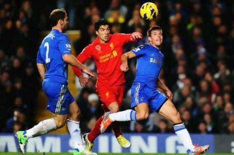 Chelsea’s Gary Cahill, left, and Liverpool’s Luis Suarez clash during the match at Stamford Bridge last night.