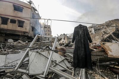 A coat hangs beside the rubble at the site of the destroyed Al-Watan Tower following Israeli air strikes in Gaza City on Sunday. EPA