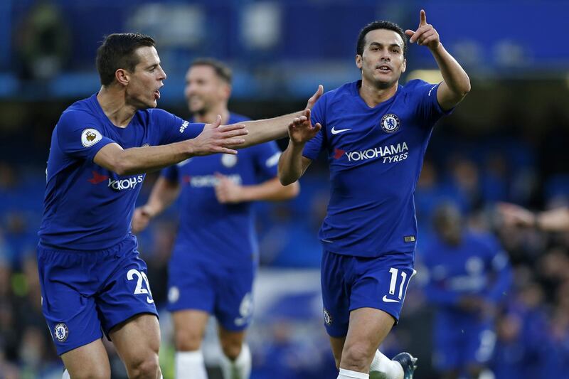 Chelsea's Spanish midfielder Pedro (R) celebrates with Chelsea's Spanish defender Cesar Azpilicueta (L) after scoring their third goal during the English Premier League football match between Chelsea and Stoke City at Stamford Bridge in London on December 30, 2017. / AFP PHOTO / Ian KINGTON / RESTRICTED TO EDITORIAL USE. No use with unauthorized audio, video, data, fixture lists, club/league logos or 'live' services. Online in-match use limited to 75 images, no video emulation. No use in betting, games or single club/league/player publications.  / 