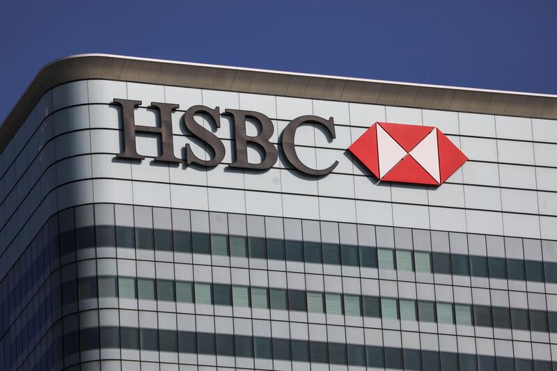 A sign sits on the HSBC Holdings Plc headquarters office building in the Canary Wharf business, financial and shopping district of London, U.K., on Friday, Sept. 18, 2020. After a pause during lockdown, lenders from Citigroup Inc. to HSBC Holdings Plc have restarted cuts, taking gross losses announced this year to a combined 63,785 jobs, according to a Bloomberg analysis of filings. Photographer: Simon Dawson/Bloomberg