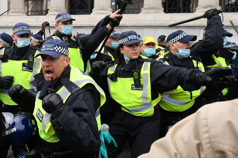 Police move in to disperse protesters in Trafalgar Square.  AFP