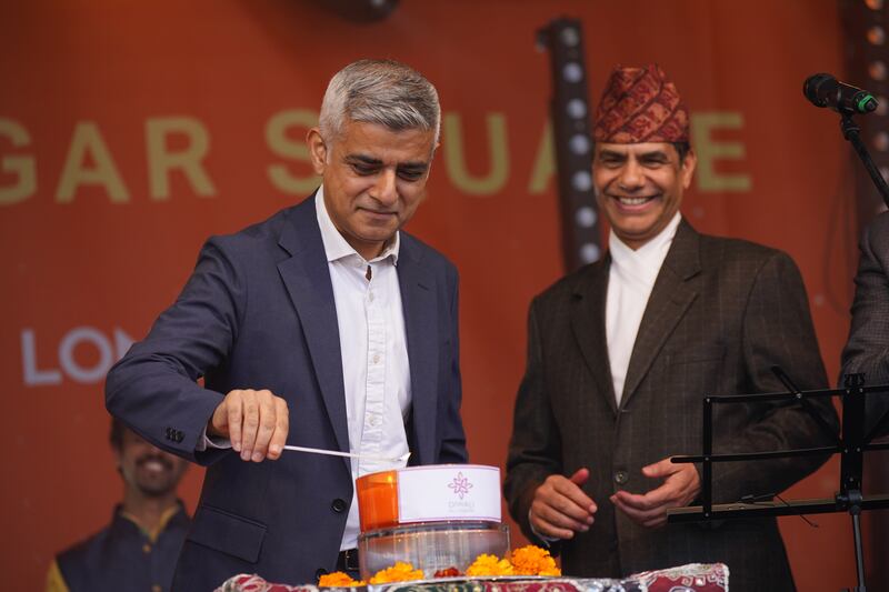 Mayor of London Sadiq Khan lights a candle during the Diwali on the Square celebration, in Trafalgar Square, London. PA Images