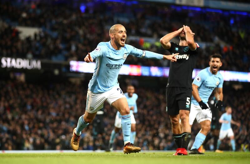 MANCHESTER, ENGLAND - DECEMBER 03:  David Silva of Manchester City celebrates scoring his sides second goal while Pablo Zabaleta of West Ham United looks dejected during the Premier League match between Manchester City and West Ham United at Etihad Stadium on December 3, 2017 in Manchester, England.  (Photo by Clive Brunskill/Getty Images)