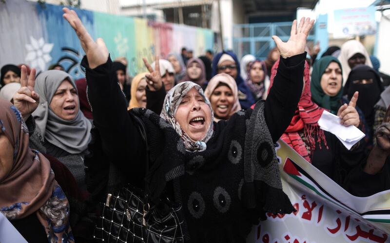 Palestinians protest outside of the United Nations' offices in al-Nusirat refugee camp in the Gaza strip on January 17, 2018 after the White House froze tens of millions of dollars in contributions.
The agency provides Palestinian refugees and their descendants across the Middle East with services including schools and medical care, but Prime Minister Benjamin Netanyahu has long accused it of hostility toward Israel and called for its closure. / AFP PHOTO / MAHMUD HAMS