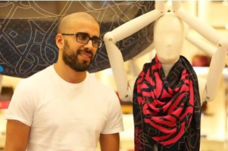 The Tunisian artist eL Seed with a printed silk scarf designed by him for Louis Vuitton. Pawan Singh / The National