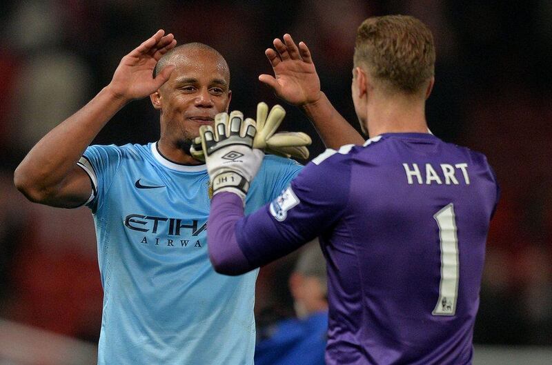 Vincent Kompany and Manchester City keeper Joe Hart celebrate at the final whistle after their 3-0 victory on Tuesday. Paul Ellis / AFP / March 25, 2014