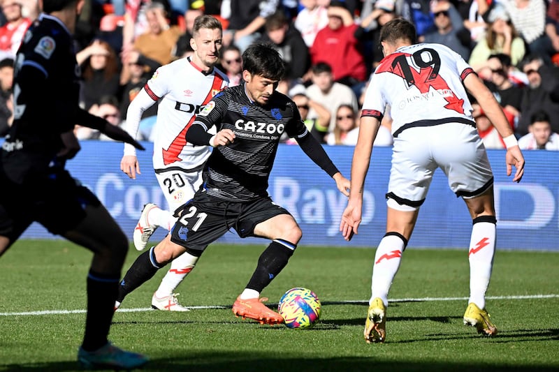 Real Sociedad's Spanish midfielder David Silva (C) fights for the ball with Rayo Vallecano's Albanian defender Ivan Balliu (L) and Rayo Vallecano's French defender Florian Lejeune during the Spanish league football match between Rayo Vallecano de Madrid and Real Sociedad at the Vallecas stadium in Madrid on January 21, 2023.  (Photo by OSCAR DEL POZO  /  AFP)