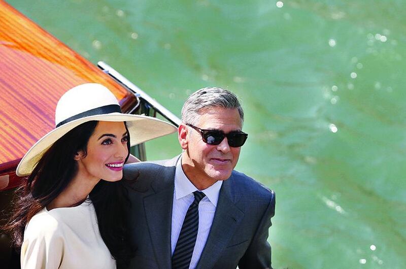 Actor George Clooney and British lawyer Amal Alamuddin leave the palazzo Ca Farsetti on a taxi boat on September 29 in Venice, after a civil ceremony to officialise their wedding. Pierre Teyssot / AFP