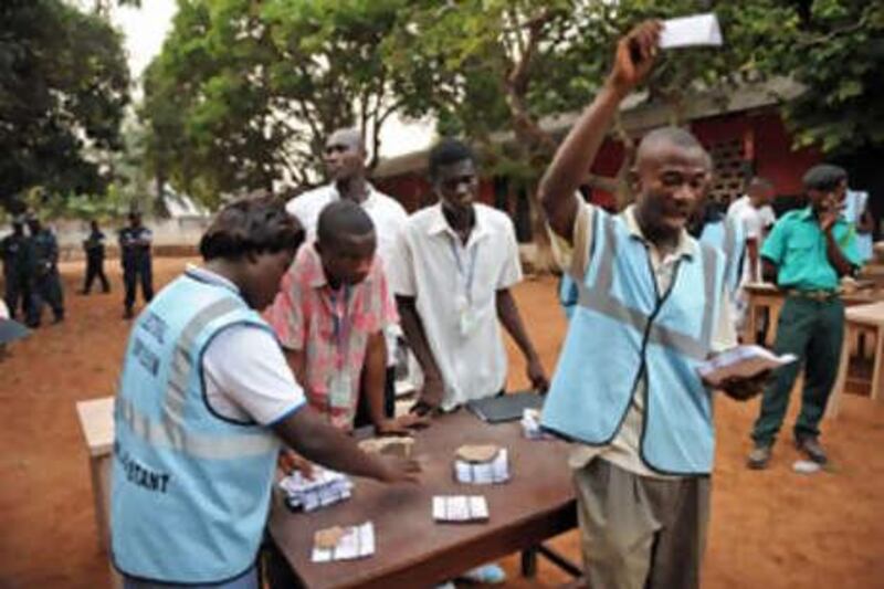 Electoral officers count the ballots at an Accra polling station after the presidential elections.