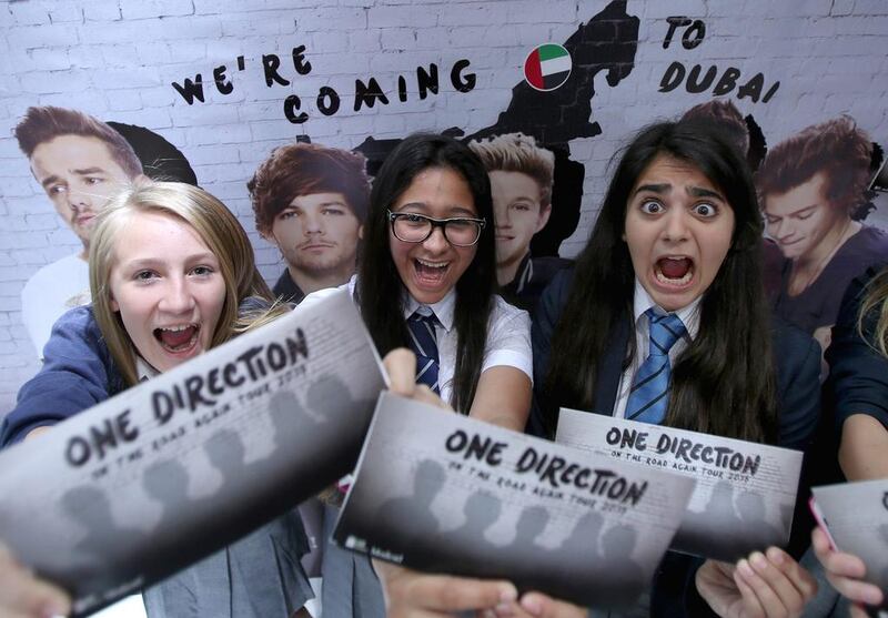 Fans hold up tickets they bought for the One Direction Dubai Concert, which will take place on April 4, 2015, on May 22, 2014 in Dubai, United Arab Emirates. Francois Nel / Getty Images