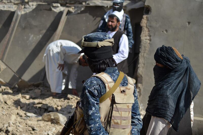 Taliban members stand guard in front of the rubble of a suspected ISIS hideout, during an operation against ISIS-Khorasan. Photo: AFP