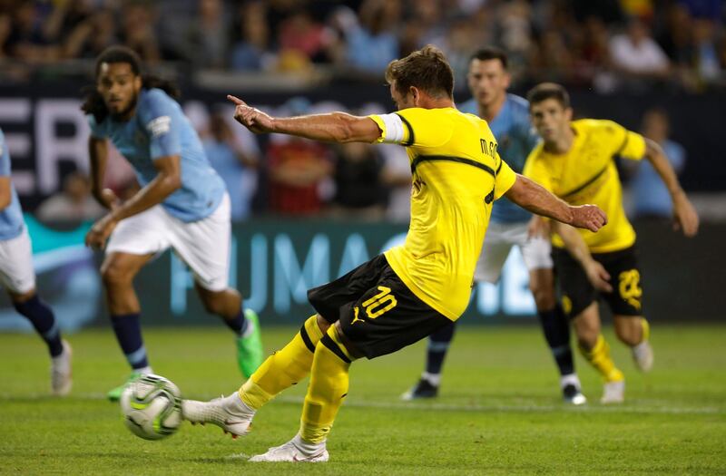 Borussia Dortmund's Mario Gotze scores their first goal from a penalty. Reuters