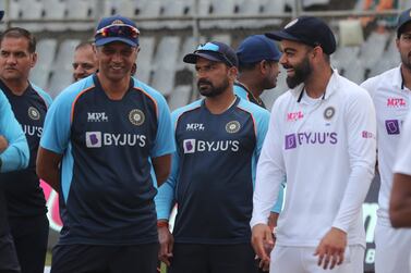 India's Virat Kohli , right, speaks with coach Rahul Dravid , left, after winning on the day four of their second test cricket match with New Zealand in Mumbai, India, Monday, Dec.  6, 2021. India won the won the series 1-0.  (AP Photo / Rafiq Maqbool)