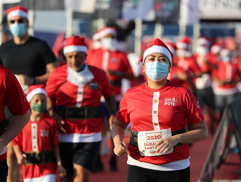 Dubai, United Arab Emirates - December 11, 2020: People take part in the Santa fun run at Dubai festival city. Friday, December 11th, 2020 in Dubai. Chris Whiteoak / The National