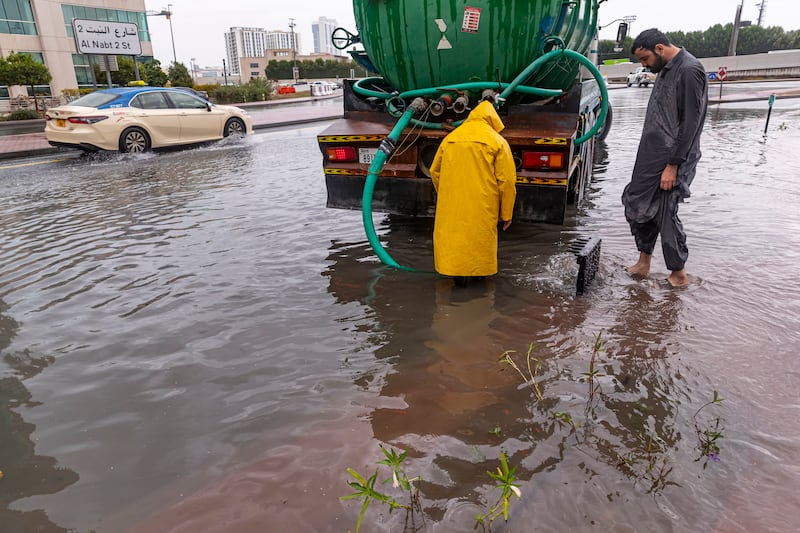 Sanitation workers clear drains that have been choked by heavy rain in Dubai.
Antonie Robertson/The National