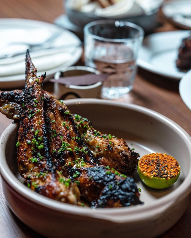 Chicken wings with a coconut-spiced marinade, togarashi and lime. All photos: 11 Woodfire / John Marsland Photography