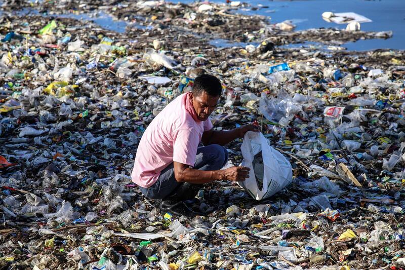 A volunteer participates in collecting garbage from Manila bay during the 33rd International Coastal Cleanup in Manila. Around 8,000 volunteers participated during the cleanup a week after Typhoon Mangkhut ravaged the country. AFP