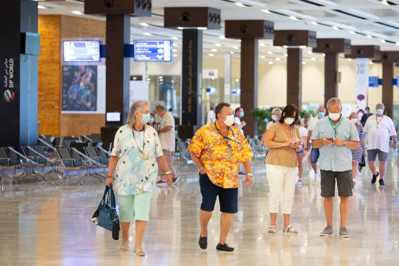 Cruise passengers disembark at the terminal.