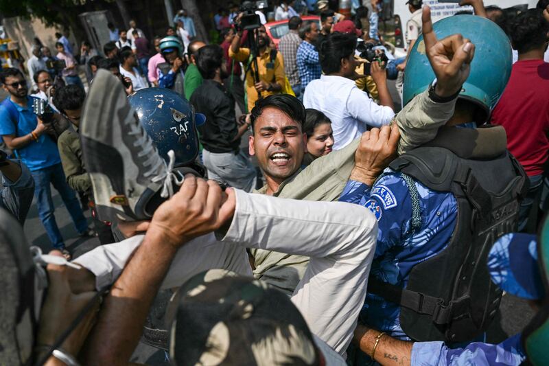 Police detain AAP supporters. AFP