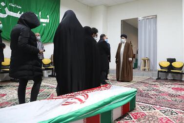Iran's Judiciary Chief Ayatollah Ebrahim Raisi pays respects to the body of slain scientist Mohsen Fakhrizadeh among his family, in the capital Tehran on November 28, 2020.  AFP 