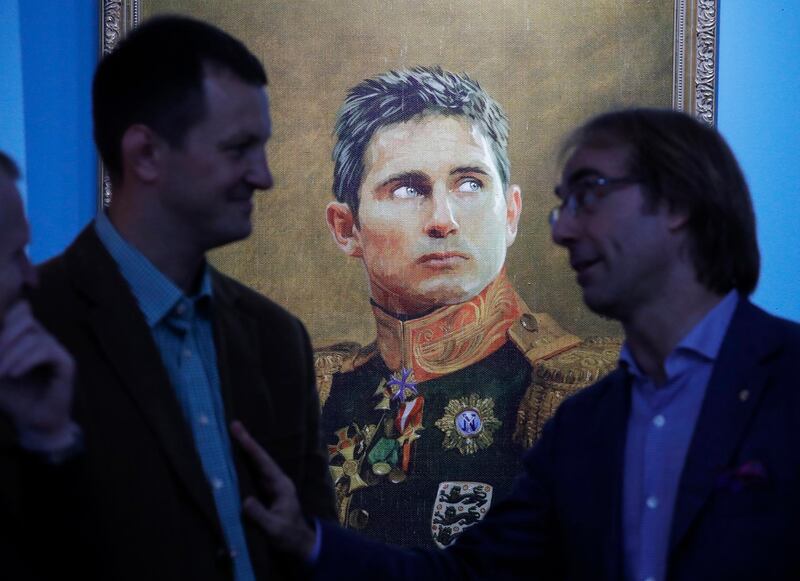 Visitors speak in front of portrait of English football manager Frank Lampard at the Museum of Academy of Arts at an exhibition within the cultural programme at the World Cup in St.Petersburg, Russia. Dmitri Lovetsky / AP Photo