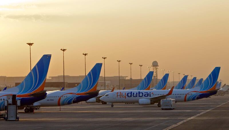 Aircraft pushing back from a row at the gate