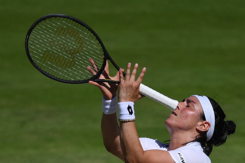 Ons Jabeur throws her racket after losing a point. AFP