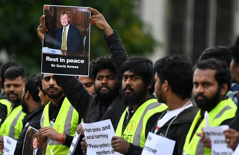 People from the Tamil community hold a vigil for MP Sir David Amess outside parliament in London, Britain, 18 October 2021.  British Prime Minister Johnson is to lead tributes to MP David Amess at parliament later today.  Amess was stabbed to death at a church in Leigh-on-Sea on 15 October.   EPA / ANDY RAIN