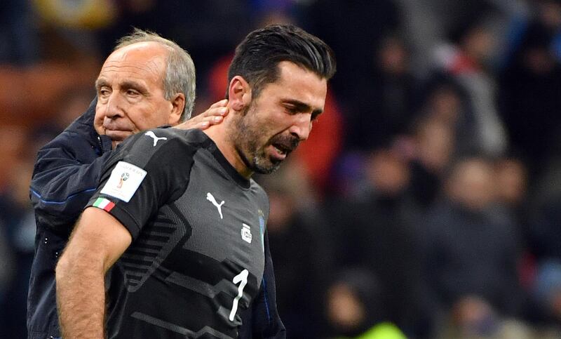 Italy coach Gian Piero Ventura, left, consoles Gianluigi Buffon at the end of the World Cup qualifying play-off return leg soccer match between Italy and Sweden, at the San Siro stadium in Milan, Italy, Monday, Nov. 13, 2017. Four-time champion Italy has failed to qualify for World Cup; Sweden advances with 1-0 aggregate win in playoff. (Daniel Dal Zennaro/ANSA via AP)