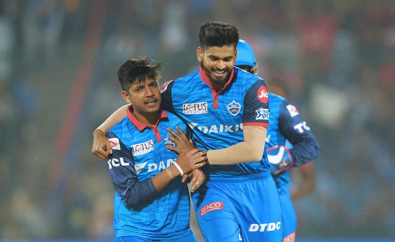 Delhi Capitals bowler Sandeep Lamichhane (L) celebrates with team captain Shreyas Iyer after he dismissed Kings XI Punjab cricketer Chris Gayle during the 2019 Indian Premier League (IPL) Twenty20 cricket match between Delhi Capitals and Kings XI Punjab at the Feroz Shah Kotla cricket stadium in New Delhi on April 20, 2019. (Photo by Sajjad HUSSAIN / AFP) / ----IMAGE RESTRICTED TO EDITORIAL USE - STRICTLY NO COMMERCIAL USE-----