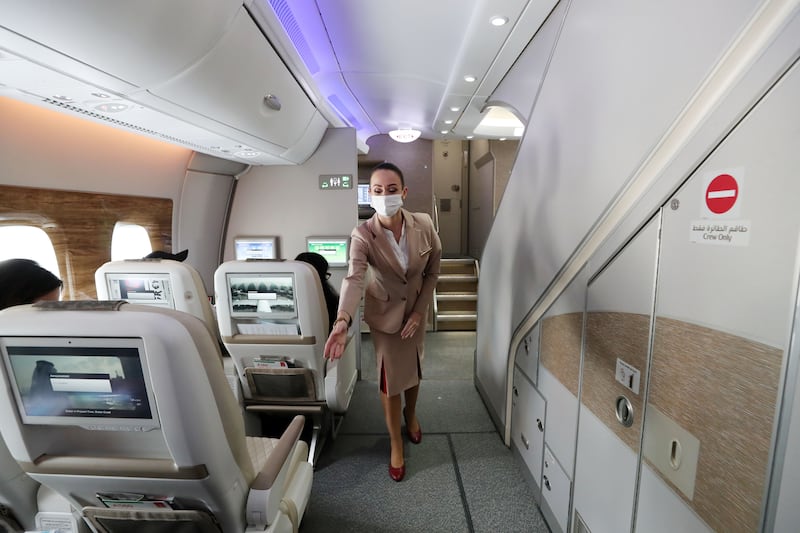 An Emirates crew member details safety features for travellers flying premium economy. 