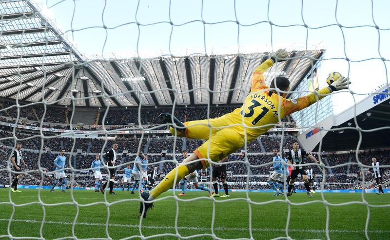 Manchester City goalkeeper Ederson dives in vain trying to stop Newcastle United's Jonjo Shelvey's scoring during their Premier League draw at St James' Park on Saturday, November 30. Getty