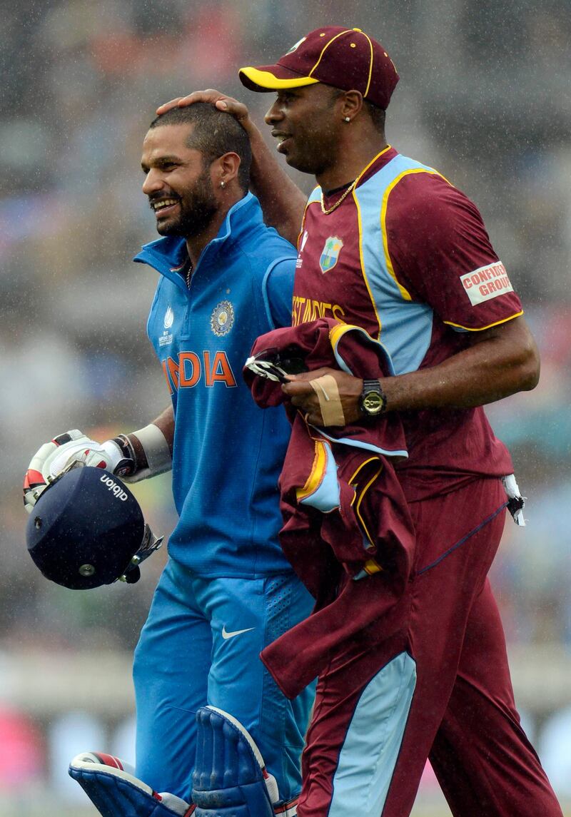 India's Shikhar Dhawan leaves the field with West Indies' Kieron Pollard (R) as the rain falls during the ICC Champions Trophy group B match at The Oval cricket ground in London, England June 11, 2013. REUTERS/Philip Brown (BRITAIN - Tags: SPORT CRICKET) *** Local Caption ***  PB21_CRICKET-CHAMPI_0611_11.JPG
