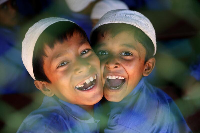 Rohingya refugee boys smile to the camera in Cox's Bazar, Bangladesh. Reuters