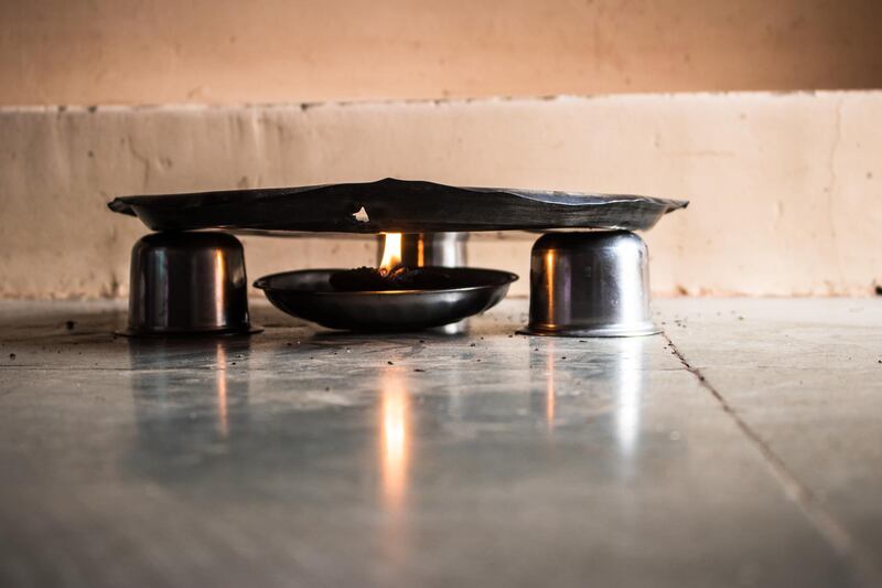 Three steel bowls are arranged in a triangular form that acts as a stand for this plate.