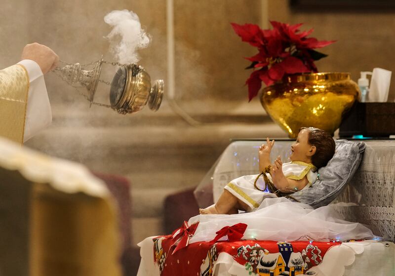 A priest swings burners with incense at St Joseph's Catholic Church in Cairo. AP