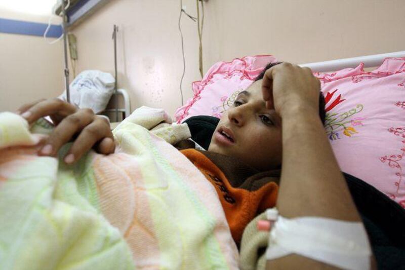 Wounded Gazan, Alaa Moustafa Saad, 13, lies in a hospital bed at Nasser Institute Hospital in Cairo.