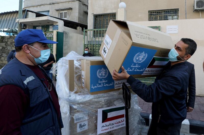 A worker unloads boxes containing ventilators delivered by the World Health Organization (WHO) and donated by Kuwait, in Gaza City. REUTERS