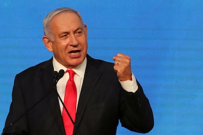 FILE PHOTO: Israeli Prime Minister Benjamin Netanyahu gestures as he delivers a speech to supporters following the announcement of exit polls in Israel's general election at his Likud party headquarters in Jerusalem March 24, 2021. REUTERS/Ammar Awad/File Photo