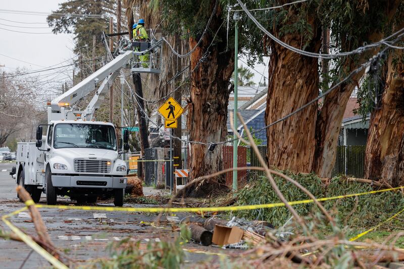 A Sacramento Municipal Utility crew repairs fallen powerlines after storms in the state's capital. Reuters