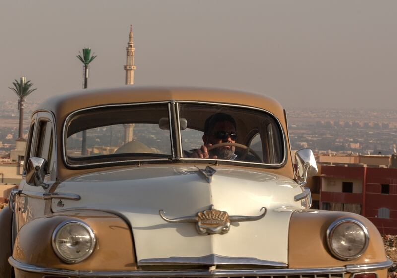 Mr Wahdan behind the wheel of his 1948 Chrysler in Obour city.