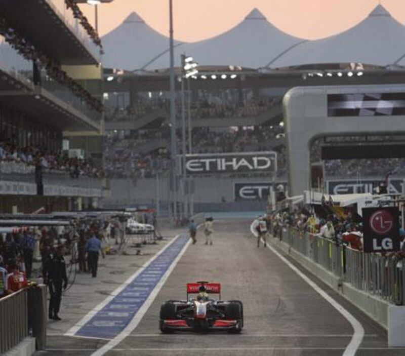 With the sun setting, Lewis Hamilton leaves the pit lane during yesterday's qualifying laps.