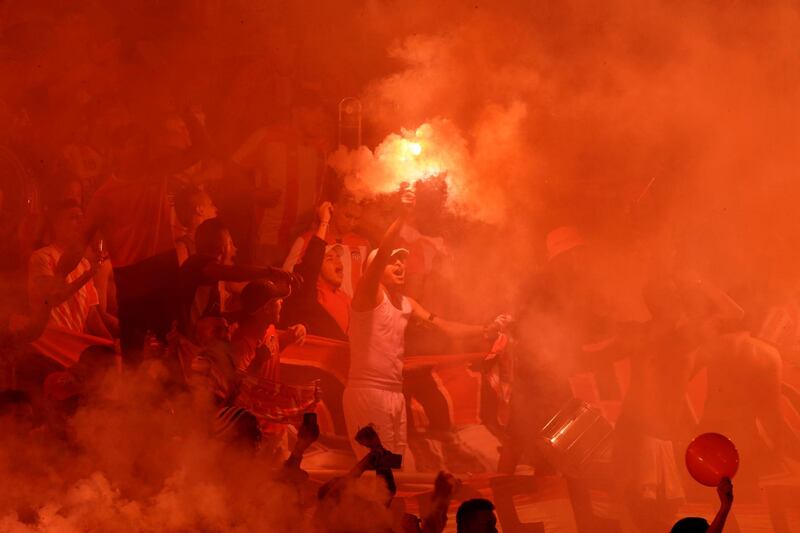 Fans of Colombia's Junior burn a flare in the stands prior a Copa Sudamericana first leg final match against Brazil's Atletico Paranaense at Metropolitano stadium in Barranquilla. AP