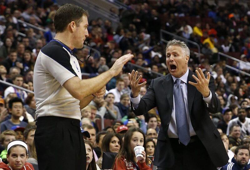 Philadelphia 76ers head coach Brett Brown, right, yells for a timeout to referee Brent Barnaky during the second half of an NBA basketball game against the Indiana Pacers, Friday, March 14, 2014, in Philadelphia. Indiana won 101-94. AP Photo/Matt Slocum